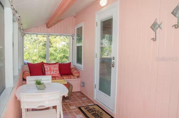13136 4th Street East Madeira Beach, FL 33708 - Photo 44 of 75 a living room with furniture and a floor to ceiling window
