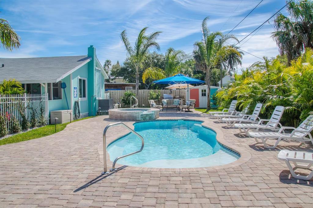 13136 4th Street East Madeira Beach, FL 33708 - Photo 53 of 75 a view of a house with swimming pool and sitting area