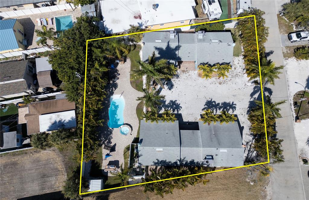 13136 4th Street East Madeira Beach, FL 33708 - Photo 74 of 75 an aerial view of a house with a yard and large trees