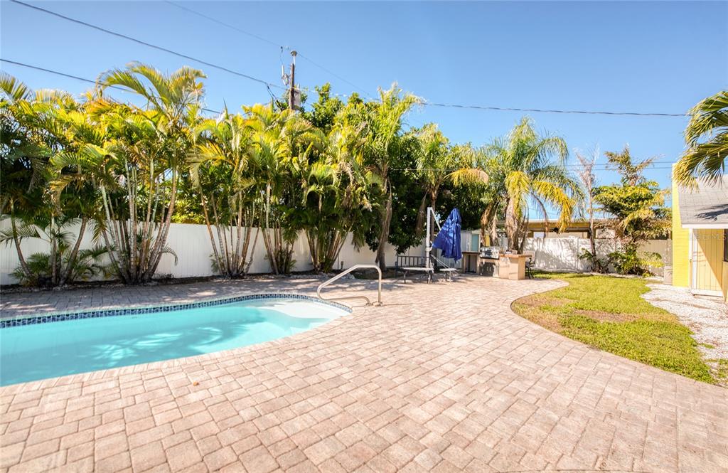 13136 4th Street East Madeira Beach, FL 33708 - Photo 8 of 75 a view of a swimming pool with an outdoor space and seating area