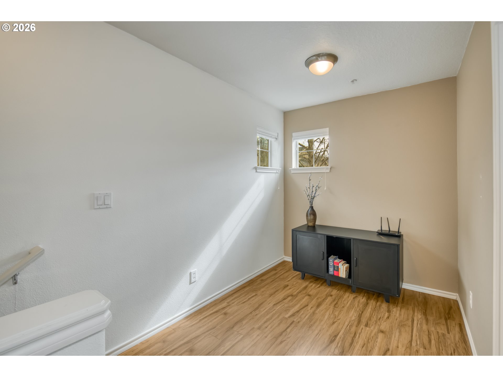 16133 Northwest Hildago Lane Portland, OR 97229 - Photo 16 of 29 a view of an empty room with wooden floor and a window