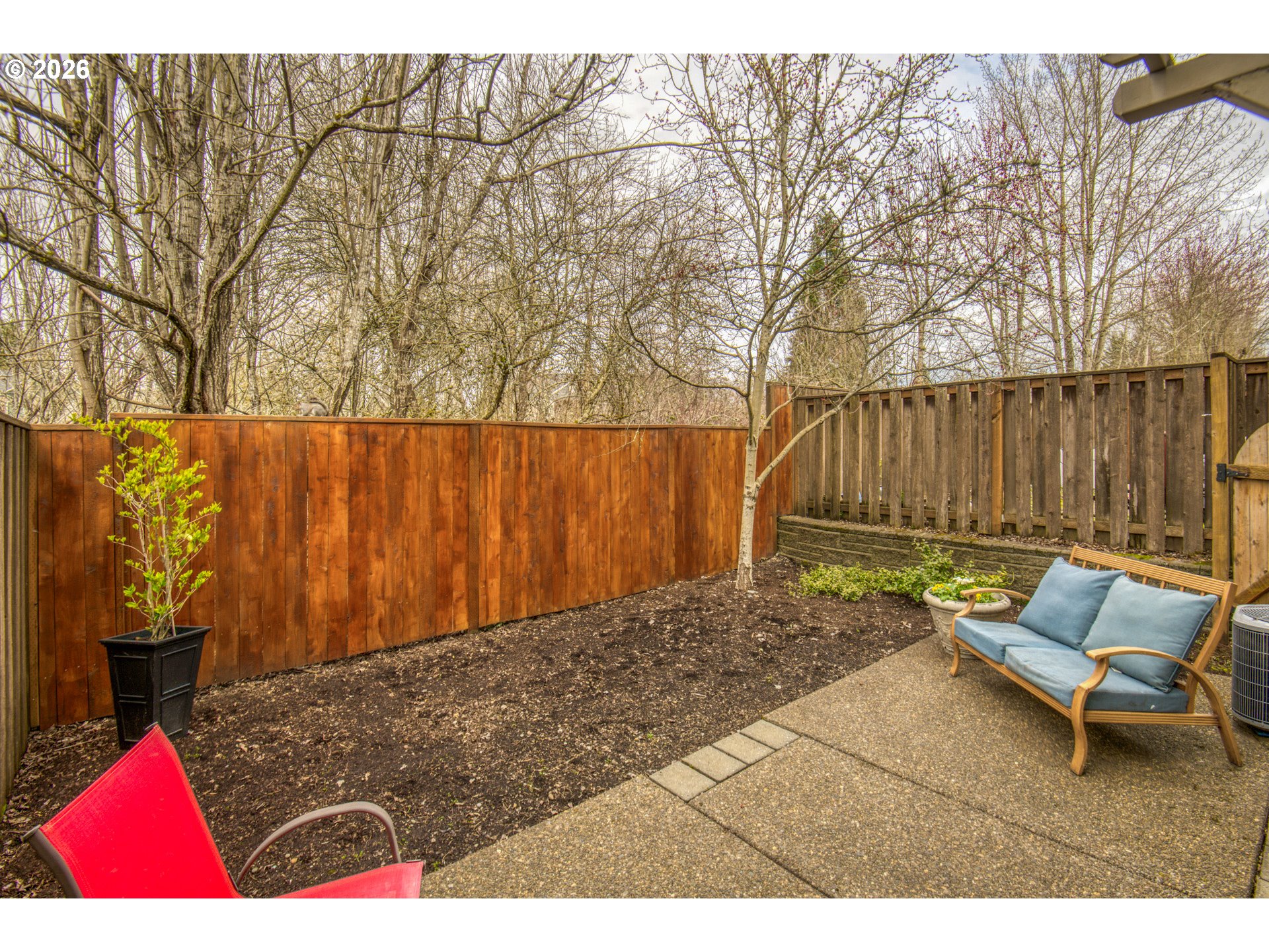 16133 Northwest Hildago Lane Portland, OR 97229 - Photo 18 of 29 a backyard of a house with table and chairs
