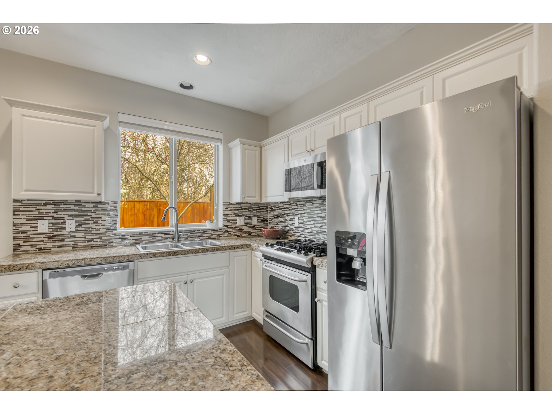 16133 Northwest Hildago Lane Portland, OR 97229 - Photo 7 of 29 a kitchen with stainless steel appliances granite countertop a refrigerator and a sink