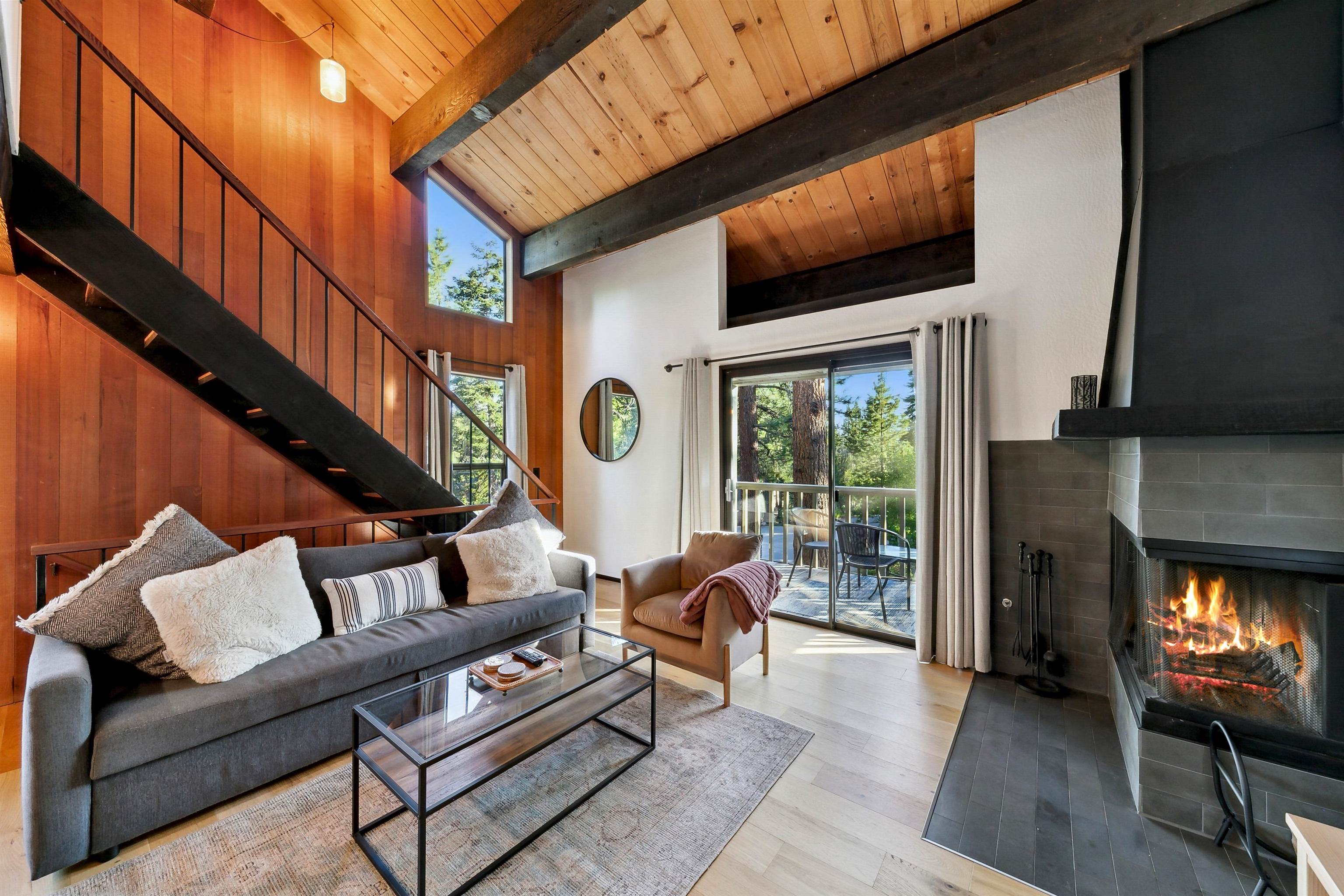 1001 Commonwealth Drive, Unit 218 Kings Beach, CA 96143 - Photo 1 of 28 a living room with furniture and a fireplace
