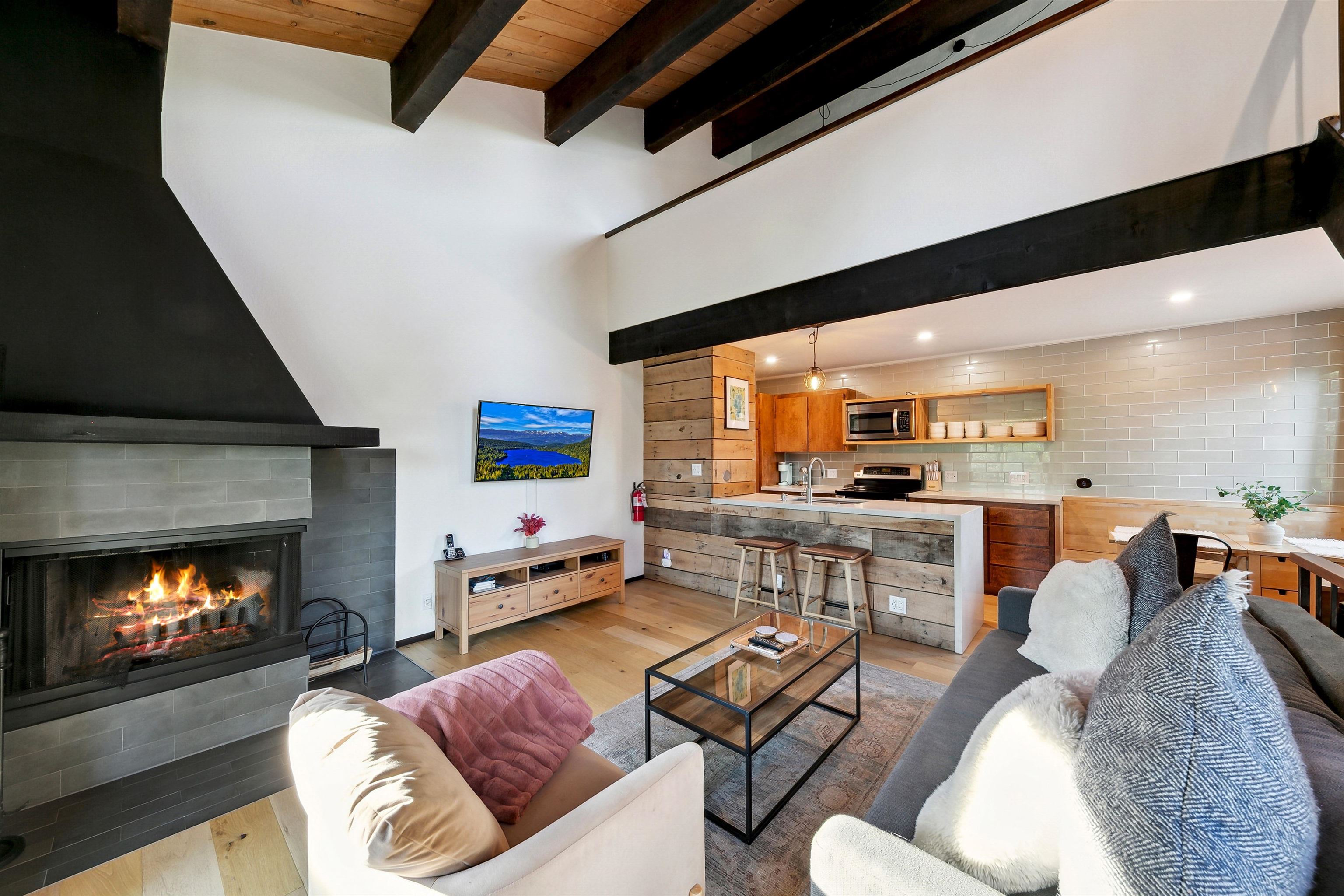 1001 Commonwealth Drive, Unit 218 Kings Beach, CA 96143 - Photo 3 of 28 a living room with furniture and a fireplace