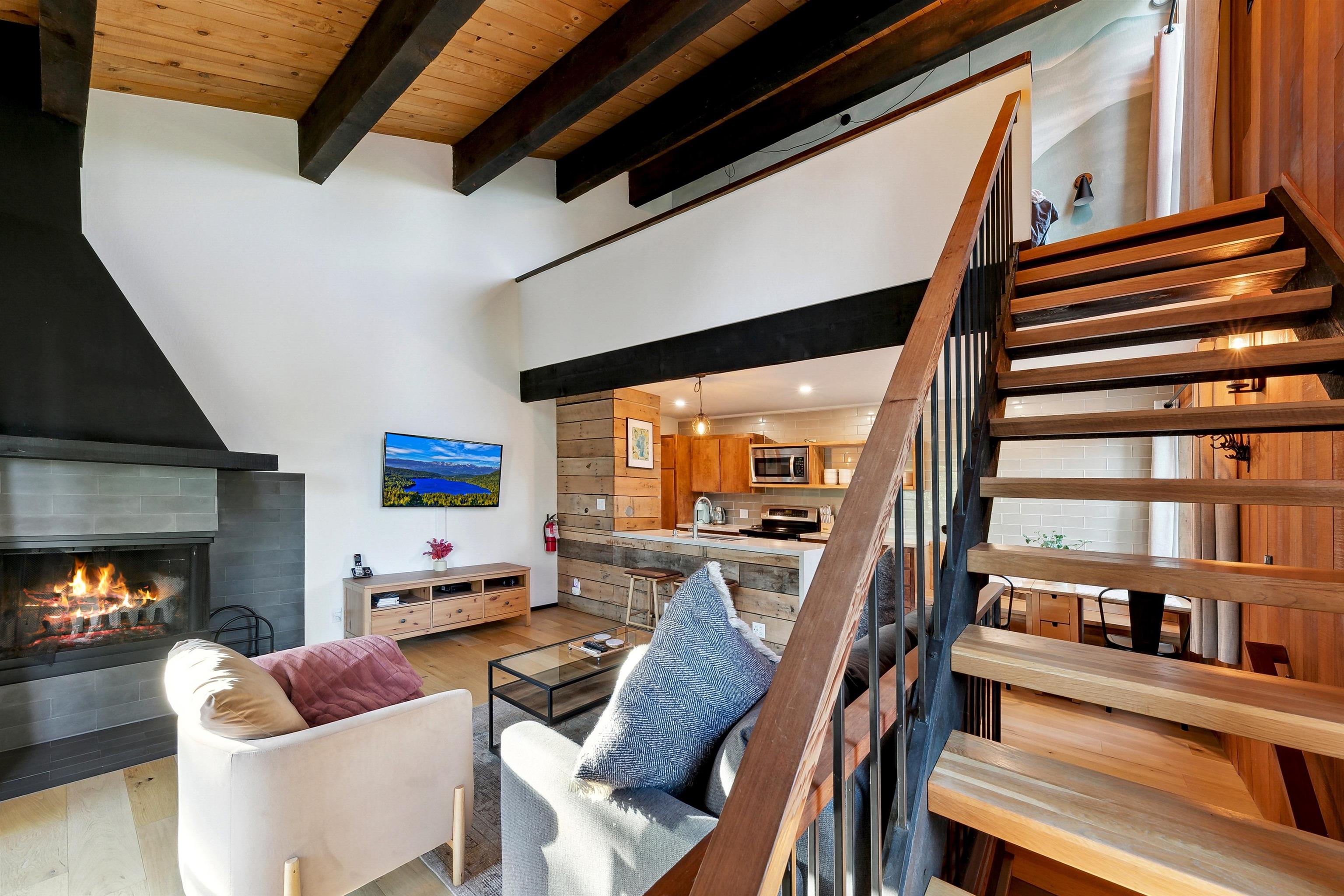1001 Commonwealth Drive, Unit 218 Kings Beach, CA 96143 - Photo 5 of 28 a living room with furniture a fireplace and a flat screen tv