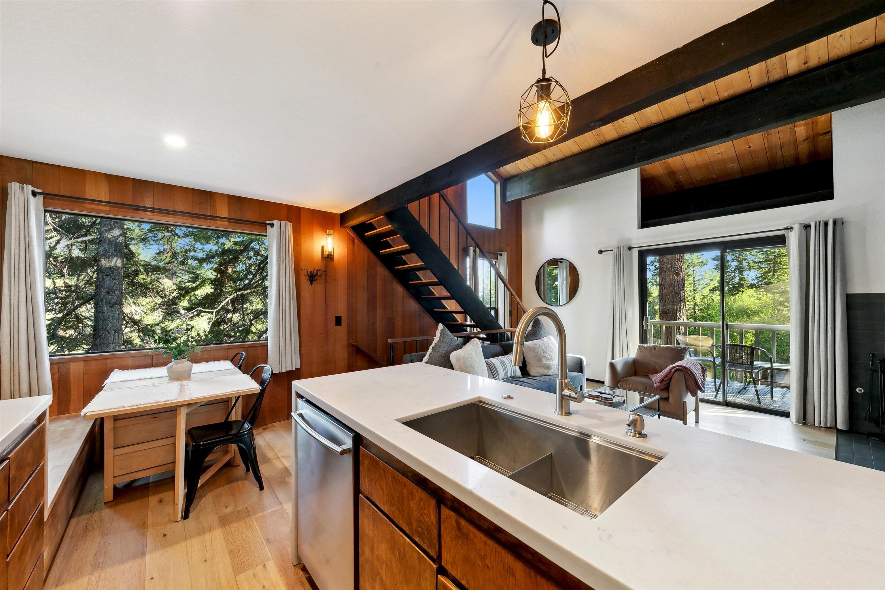 1001 Commonwealth Drive, Unit 218 Kings Beach, CA 96143 - Photo 6 of 28 a kitchen island with a sink dining table and chairs