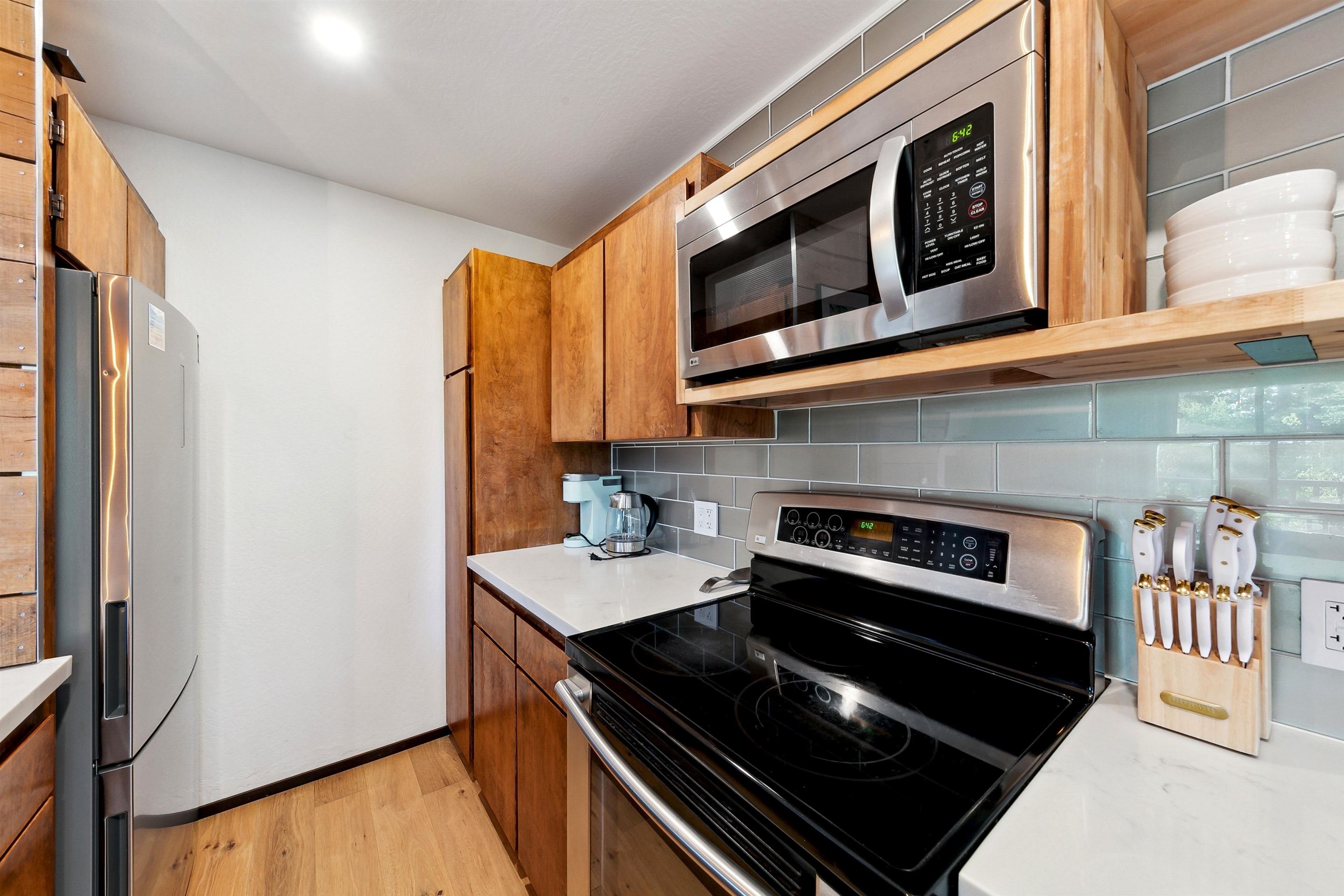 1001 Commonwealth Drive, Unit 218 Kings Beach, CA 96143 - Photo 7 of 28 a kitchen with stainless steel appliances granite countertop a stove and a microwave