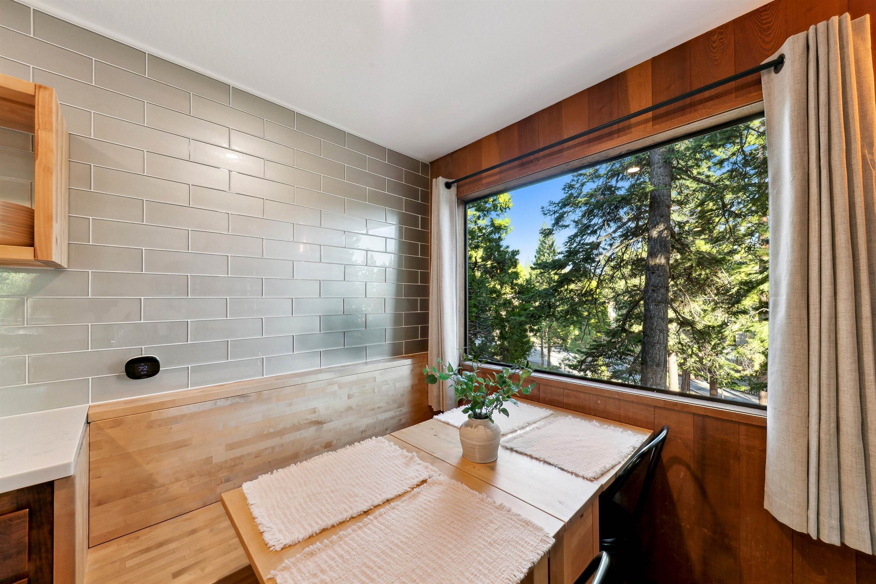 1001 Commonwealth Drive, Unit 218 Kings Beach, CA 96143 - Photo 9 of 28 a bathroom with a sink and a large mirror next to a window