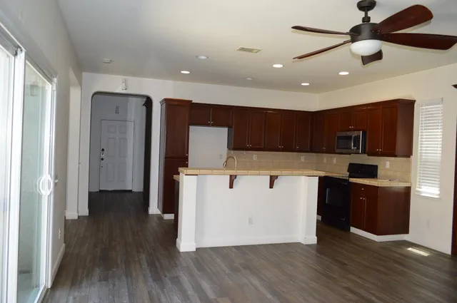 a view of empty room with wooden floor and fireplace