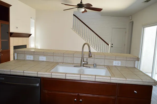 a view of a livingroom with fireplace wooden floor and staircase