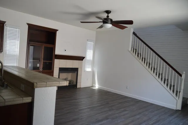 a view of a livingroom with a fireplace and wooden floor