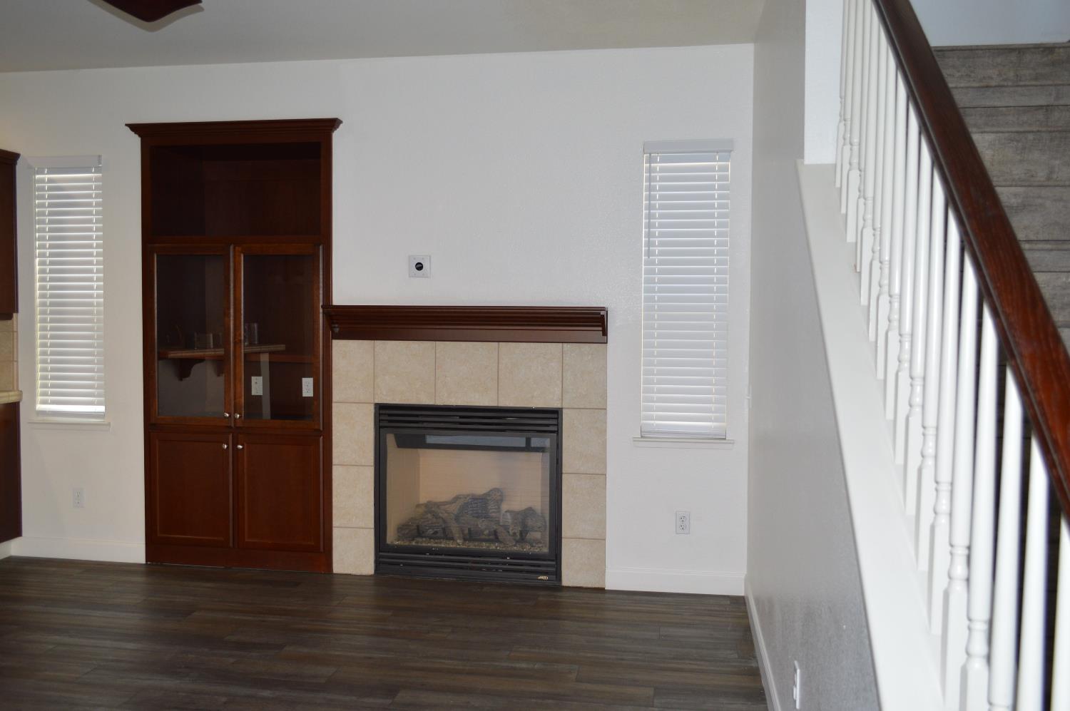 4227 Ivory Lane Turlock, CA 95382 - Photo 16 of 60 a view of a livingroom with a fireplace and wooden floor