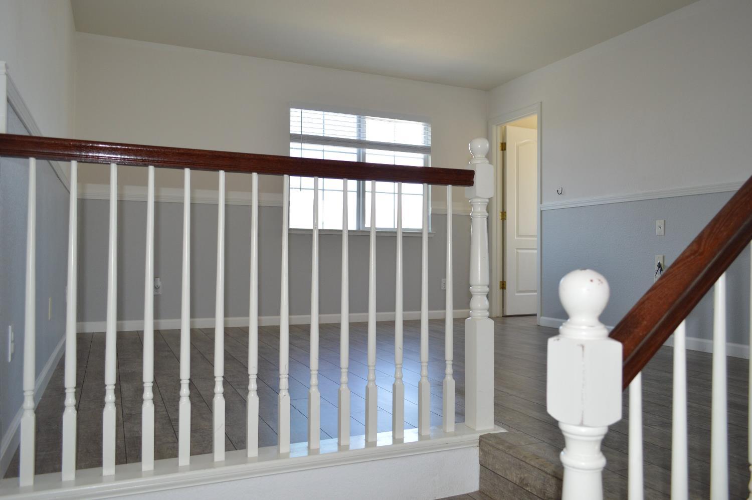 4227 Ivory Lane Turlock, CA 95382 - Photo 20 of 60 a view of staircase with wooden floor and window