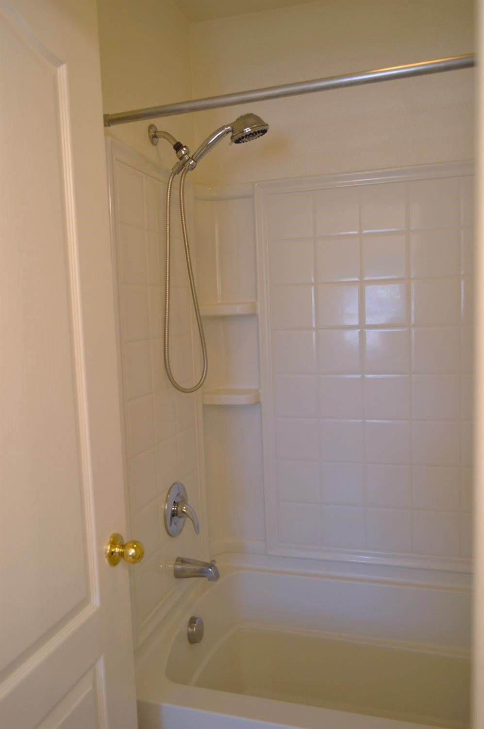 4227 Ivory Lane Turlock, CA 95382 - Photo 30 of 60 a bathroom with a bath tub with a shower