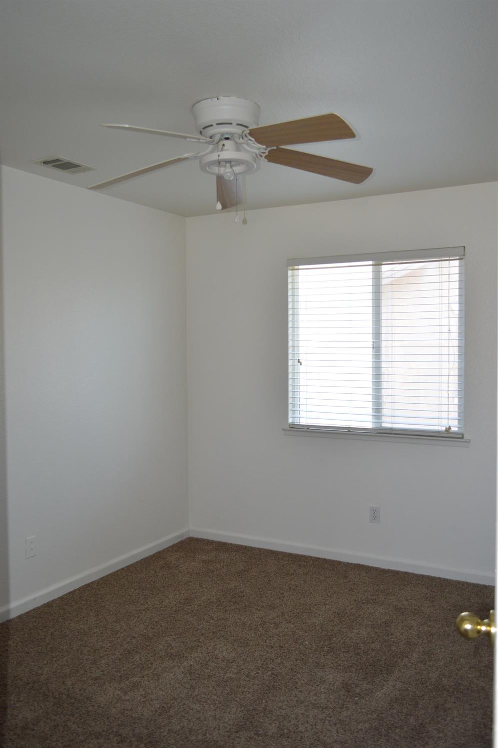 4227 Ivory Lane Turlock, CA 95382 - Photo 37 of 60 an empty room with a window