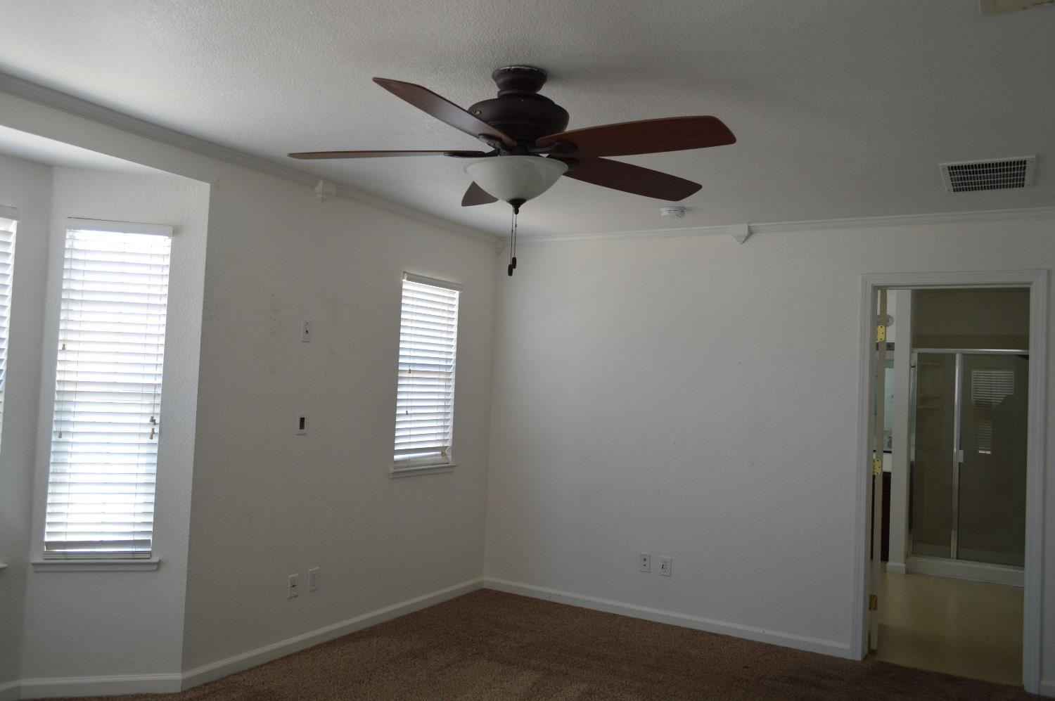 4227 Ivory Lane Turlock, CA 95382 - Photo 42 of 60 a view of empty room with wooden floor and fan