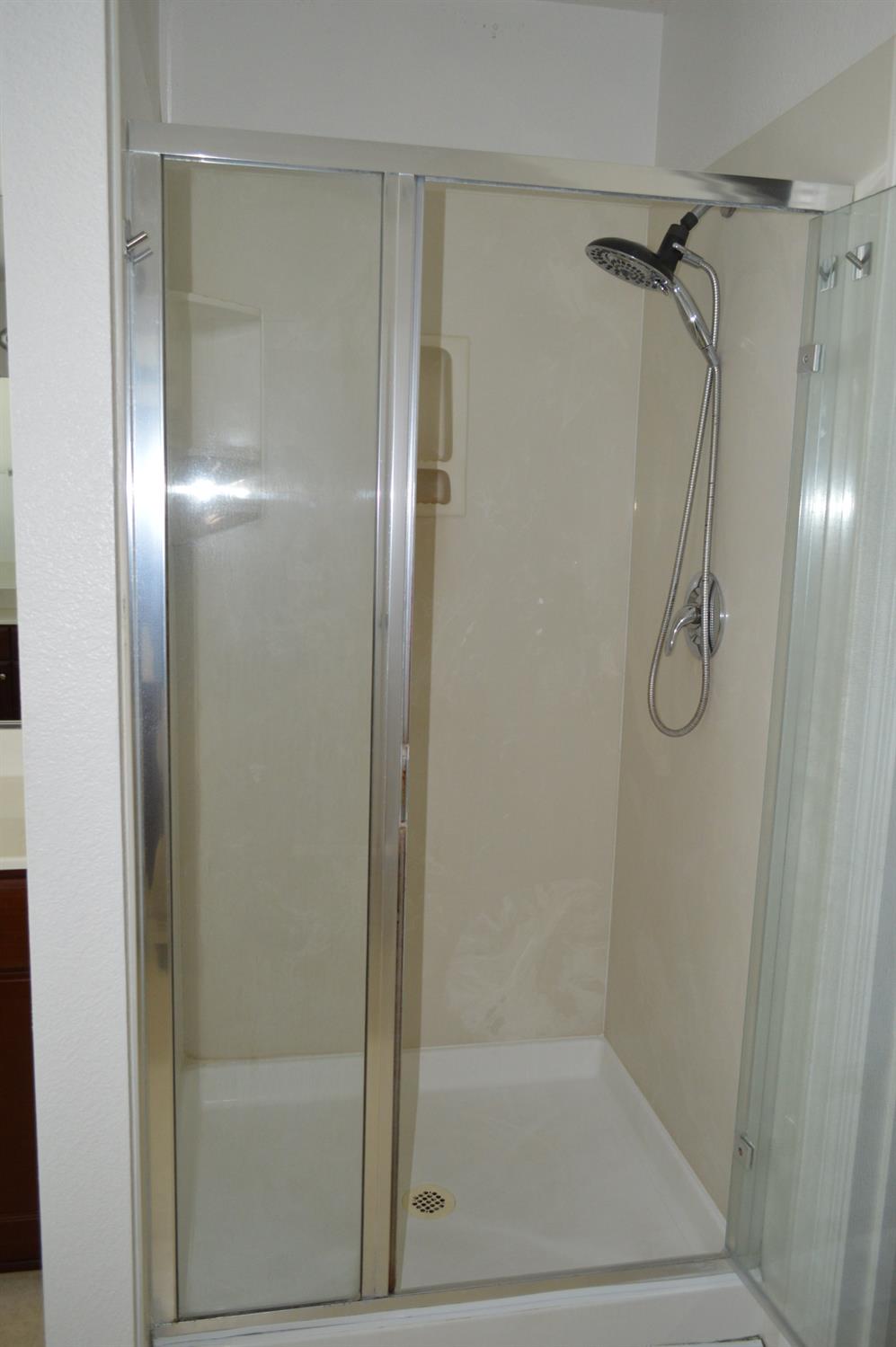 4227 Ivory Lane Turlock, CA 95382 - Photo 46 of 60 a bathroom with a glass shower door