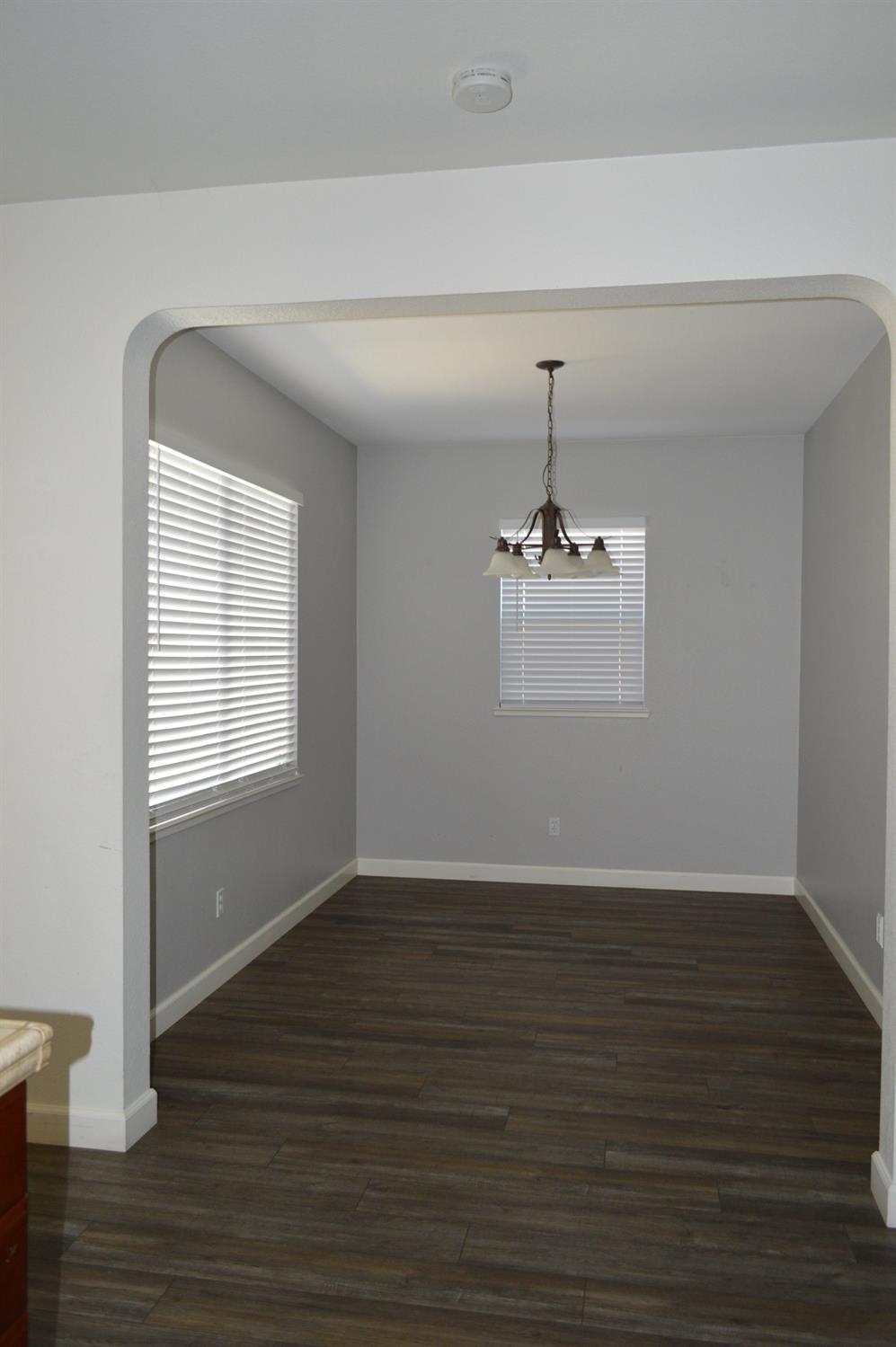 4227 Ivory Lane Turlock, CA 95382 - Photo 9 of 60 a view of a room with wooden floor and window