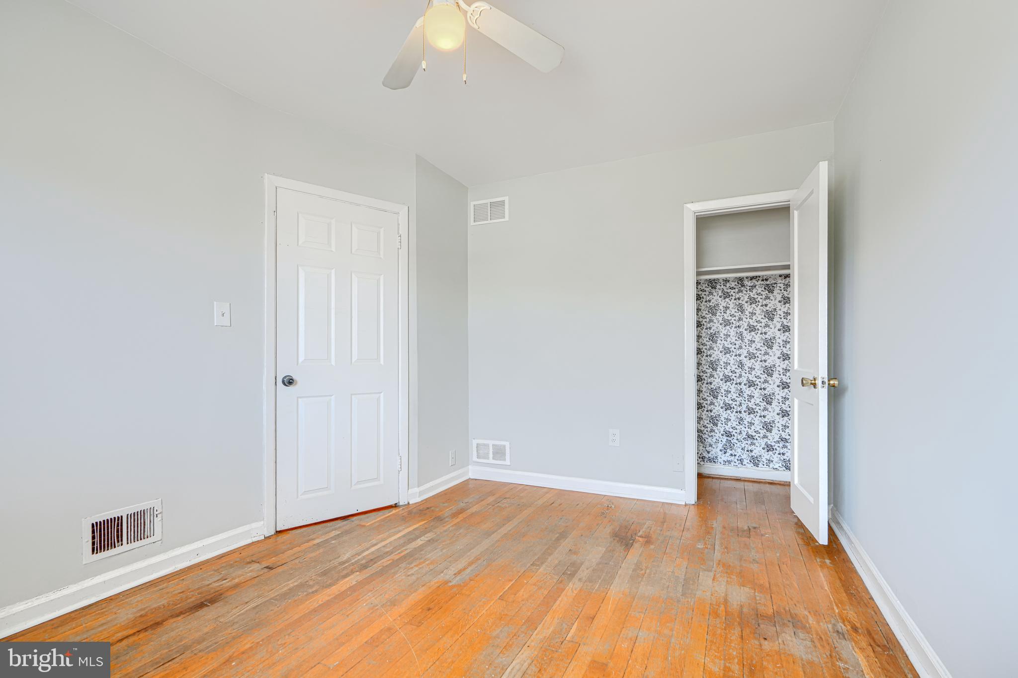 2073 Jasmine Road Baltimore, MD 21222 - Photo 18 of 29 a view of an empty room with wooden floor and a window