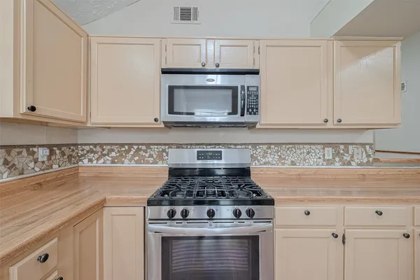 a stove top oven sitting inside of a kitchen