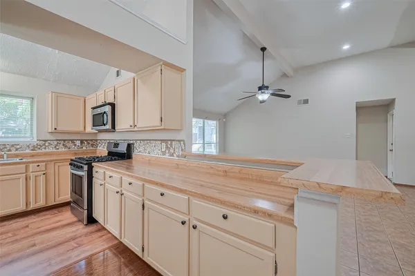 a kitchen with white cabinets and white appliances