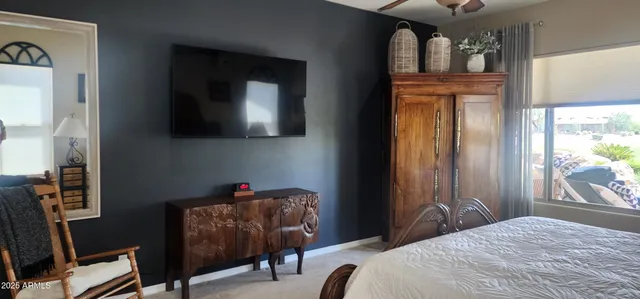 a bedroom that has a bed and a chair in it