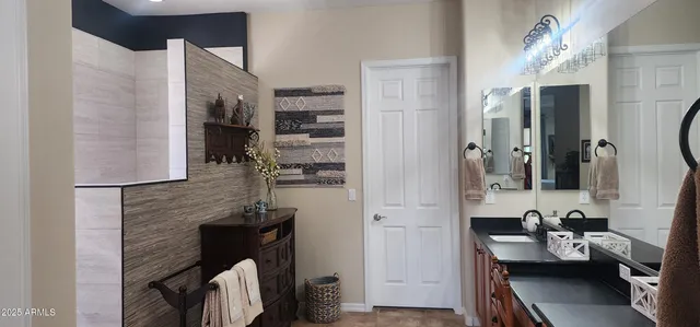 a bathroom with a sink a mirror and shower