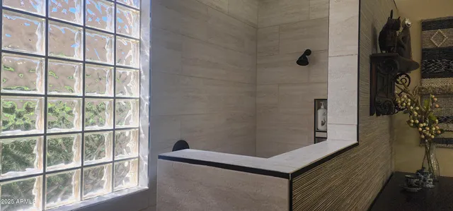 a bathroom with a shower and a sink