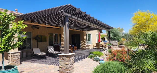 a view of a chair and tables in patio with potted plants