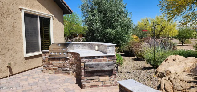 a view of a patio with table and chairs with wooden fence and plants
