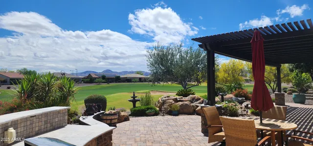 a view of a patio with couches table and chairs and potted plants