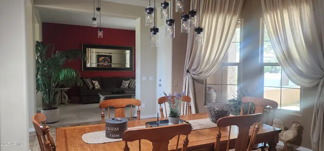 a dining room with furniture and window