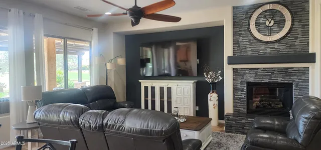 a living room with furniture a clock and a fireplace