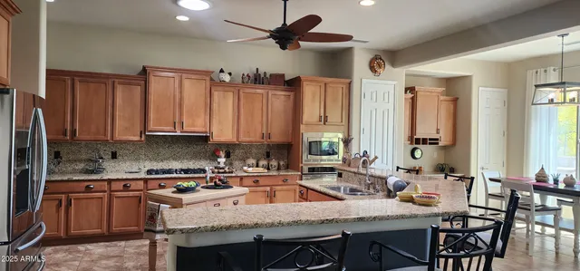 a kitchen with a stove a sink and a refrigerator