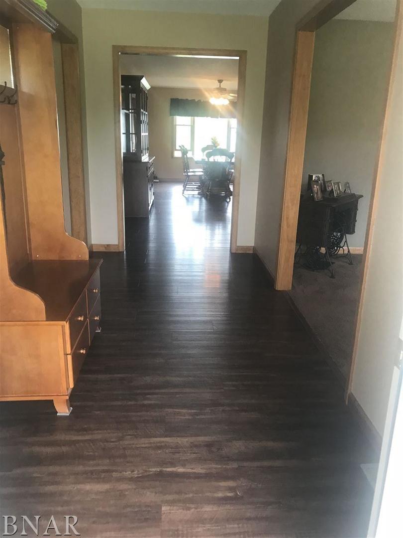 9563 Clintonia Road Clinton, IL 61727 - Photo 2 of 45 a view of a hallway with wooden floor and furniture