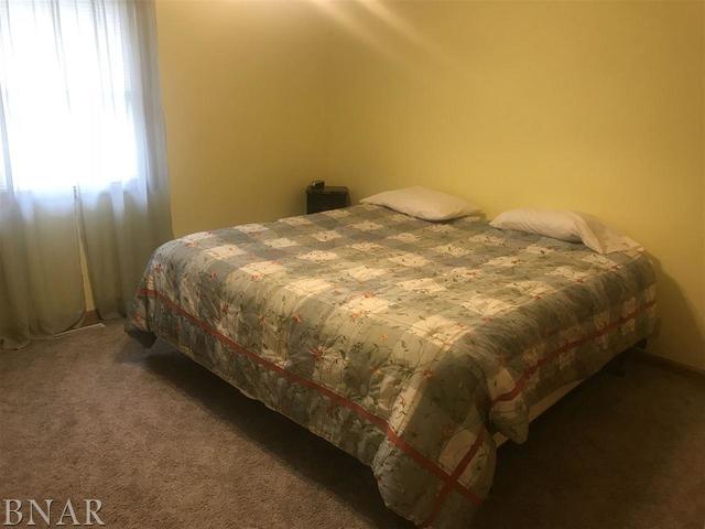 9563 Clintonia Road Clinton, IL 61727 - Photo 16 of 45 a bed sitting in a bedroom next to a window