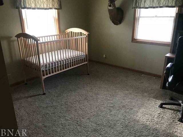 9563 Clintonia Road Clinton, IL 61727 - Photo 18 of 45 a view of a bedroom with wooden floor and a window