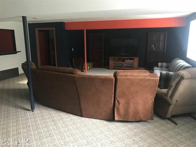 9563 Clintonia Road Clinton, IL 61727 - Photo 23 of 45 a living room with furniture and a fireplace