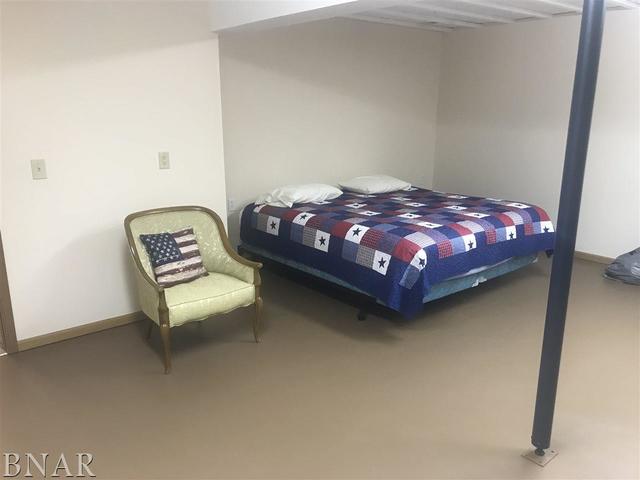 9563 Clintonia Road Clinton, IL 61727 - Photo 29 of 45 a bed sitting in a bedroom next to a window