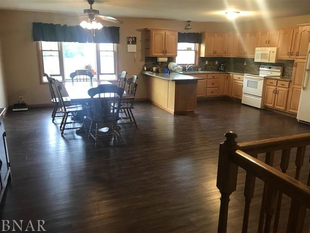 9563 Clintonia Road Clinton, IL 61727 - Photo 5 of 45 a kitchen with a table chairs and wooden floor