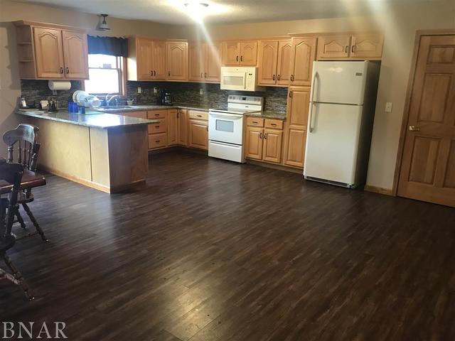 9563 Clintonia Road Clinton, IL 61727 - Photo 6 of 45 a kitchen with granite countertop a refrigerator stove and wooden floor