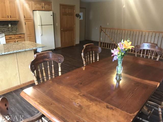 9563 Clintonia Road Clinton, IL 61727 - Photo 9 of 45 a view of a dining room with furniture a potted plant and wooden floor