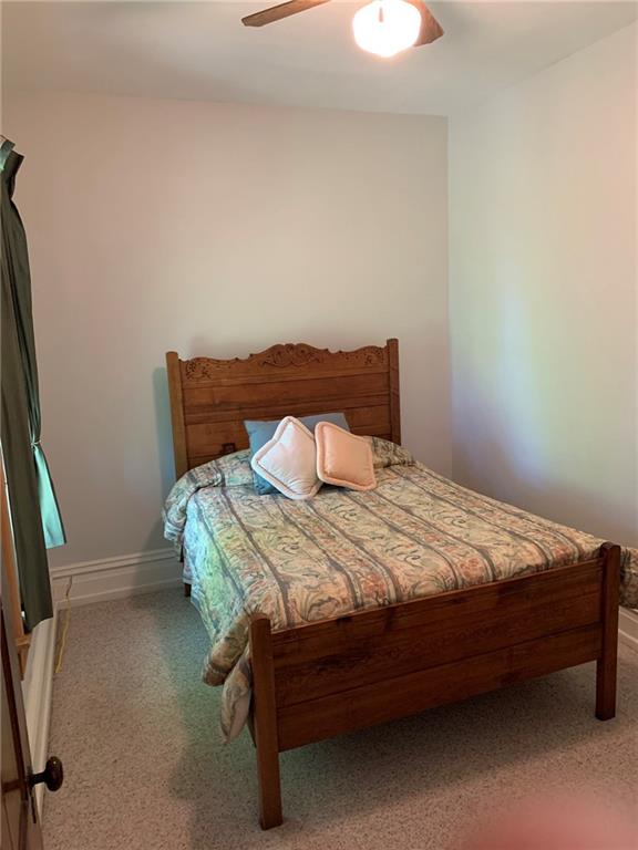 12833 Conneaut Lake Road Conneaut Lake, PA 16316 - Photo 19 of 25 a bed sitting in a bedroom next to a window
