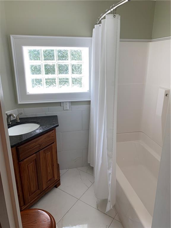 12833 Conneaut Lake Road Conneaut Lake, PA 16316 - Photo 20 of 25 a bathroom with a granite countertop sink toilet and shower