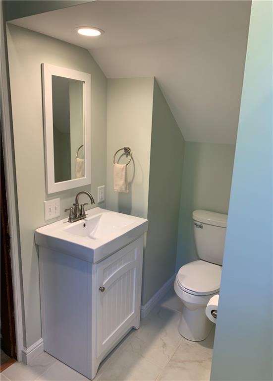 12833 Conneaut Lake Road Conneaut Lake, PA 16316 - Photo 7 of 25 a bathroom with a toilet a sink and mirror