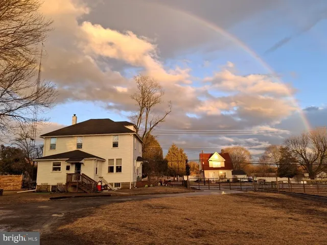 an aerial view of a house with a yard and lake