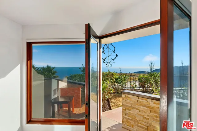 a bathroom with a double vanity sink a mirror a bathtub and next to a window