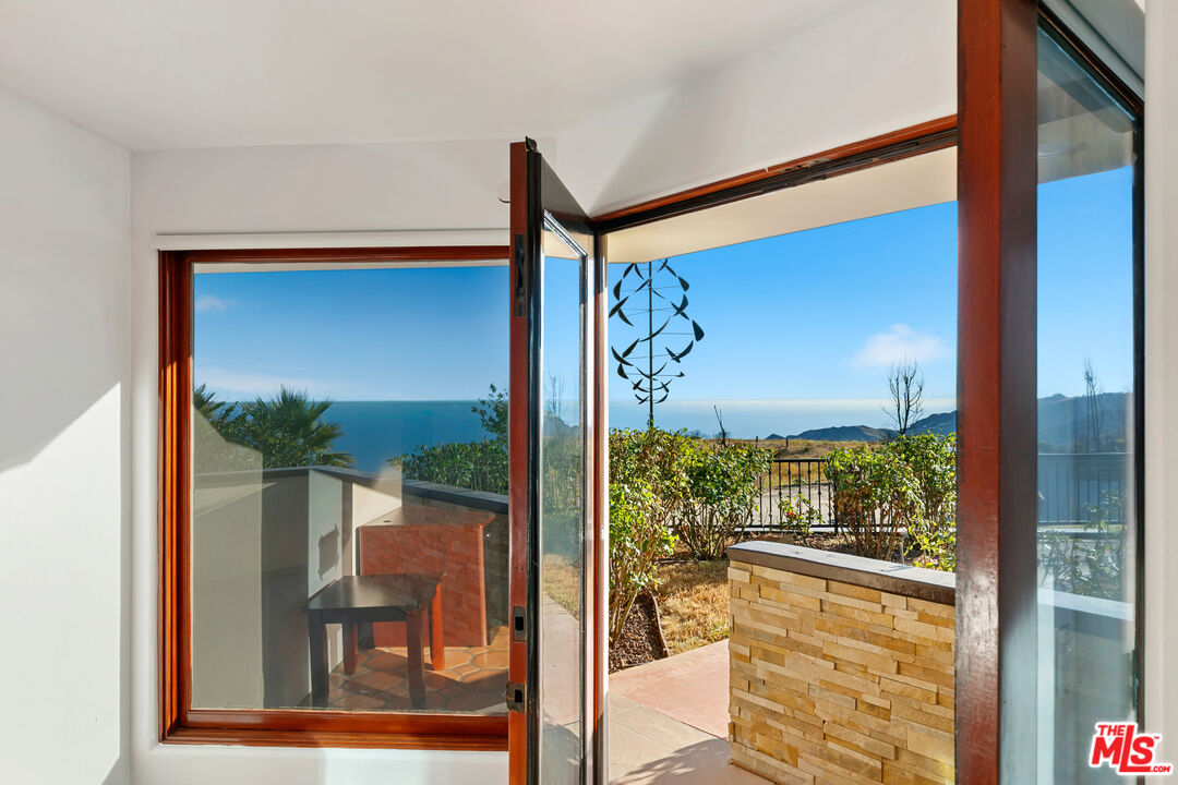 23000 Saddle Peak Road Topanga, CA 90290 - Photo 12 of 26 a front view of a house with a porch