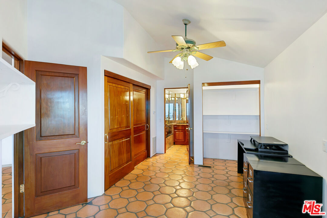 23000 Saddle Peak Road Topanga, CA 90290 - Photo 13 of 26 a view of a livingroom with a chandelier fan and windows